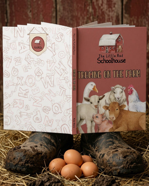 An open children's book titled 'The Little Red Schoolhouse: Tracing on the Farm!' is displayed on a rustic barn floor with straw, muddy boots, and brown eggs. The book cover features a red barn and farm animals, and the left page has a white background with alphabet illustrations.